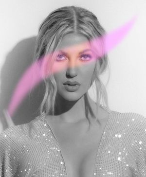 Artistic black and white portrait with pink light streak across model's face.