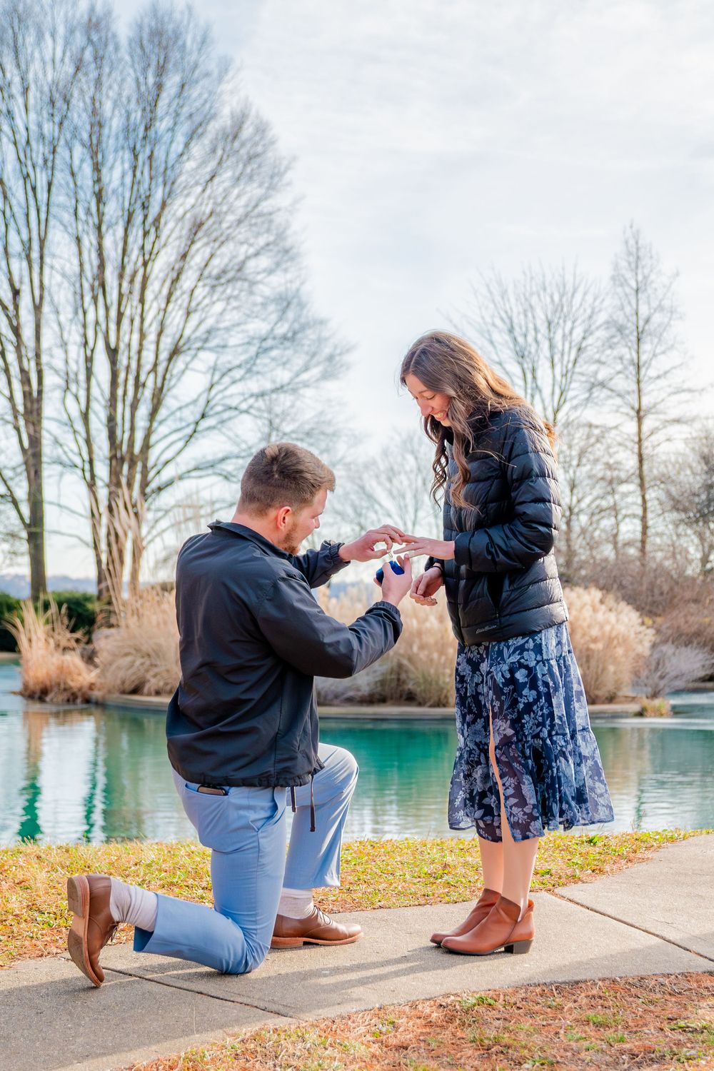 A romantic proposal scene unfolds in sequence by a serene lake with bare winter trees in the background.