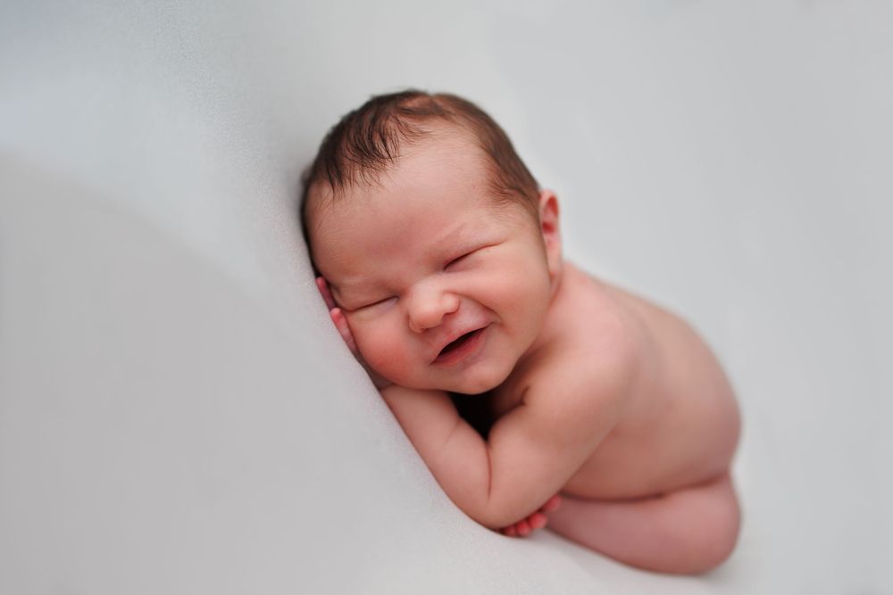 newborn baby boy photography smiling curly pose greater manchester tamside
