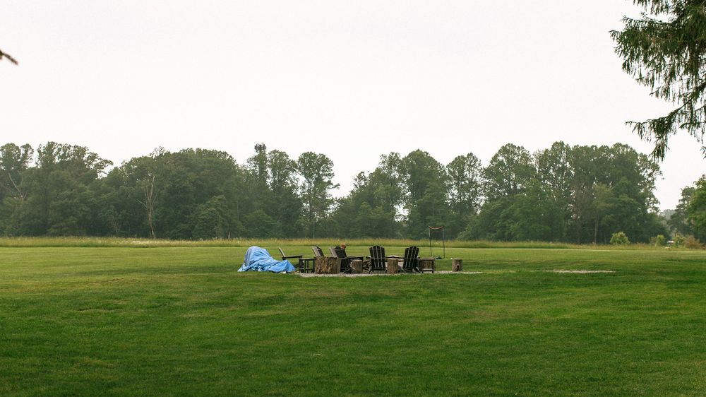 Panoramic view of a green rural landscape with distant trees and buildings.