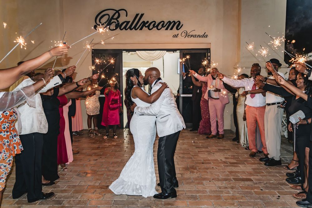 Black bride and groom grand sparkler exit from their wedding reception at the Veranda Elegant Events in Orlando. Wedding Photography, Photo