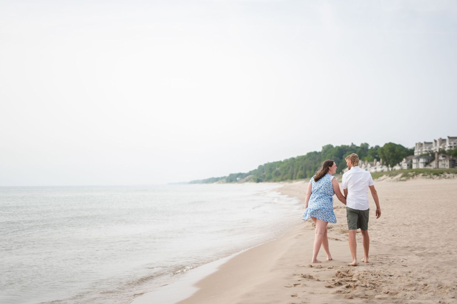 A couple taking a walk on the beach.