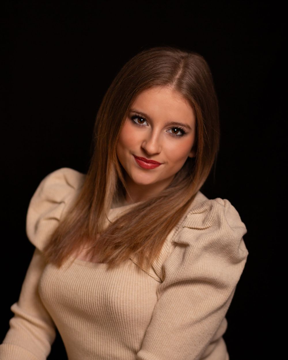 Portrait series of a person in a beige sweater against a dark background with changing poses and expressions.