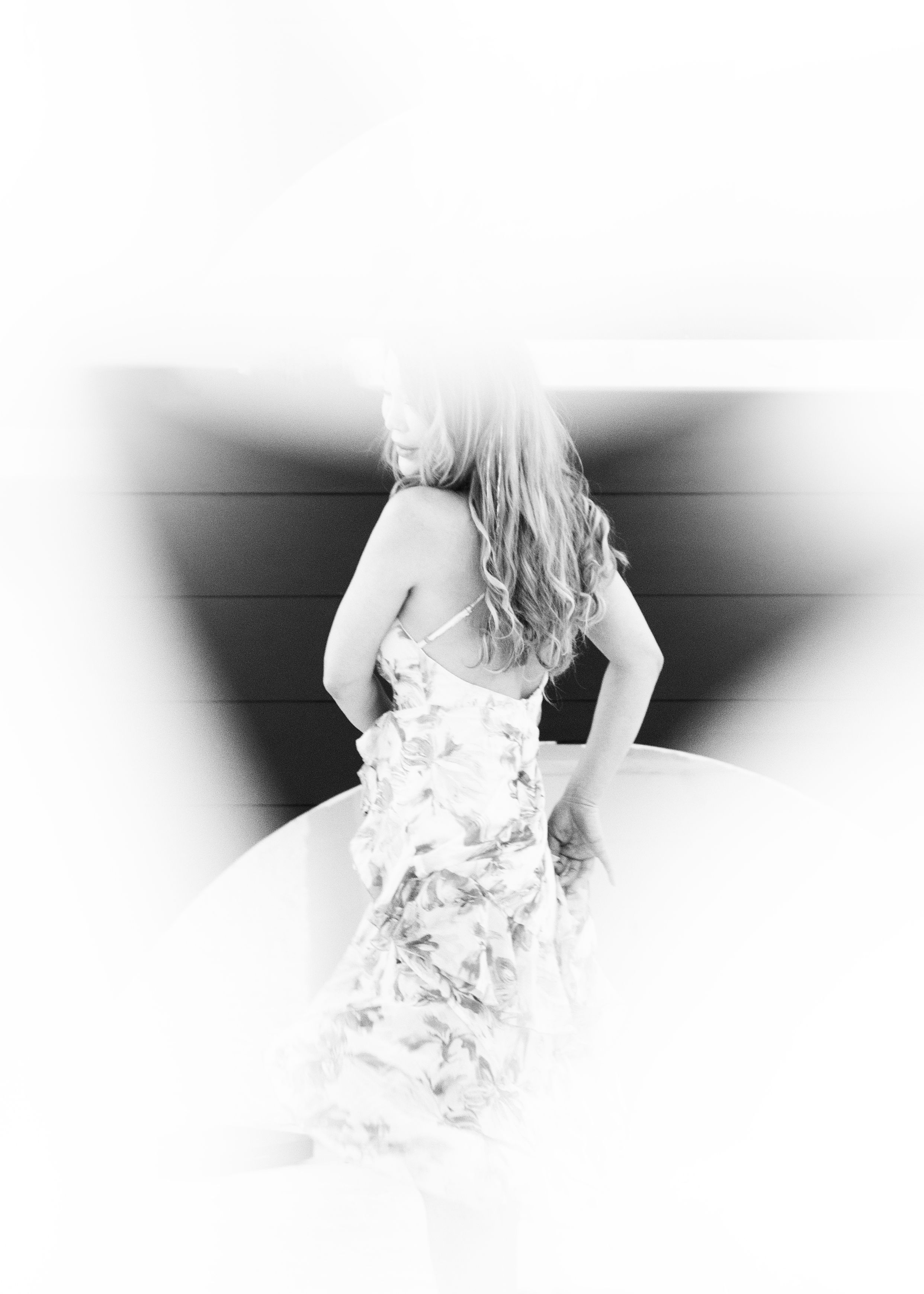 High contrast black and white portrait of woman in flowing dress.