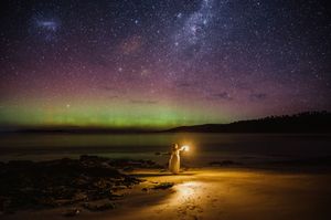 ethereal self portrait landscape image of aurora australis, Tasmania. Girl on the beach taken by Joss Jensen Photography