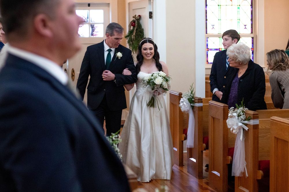 Bride walking down the aisle with her father during their wedding ceremony captured by a Chattanooga wedding photographer