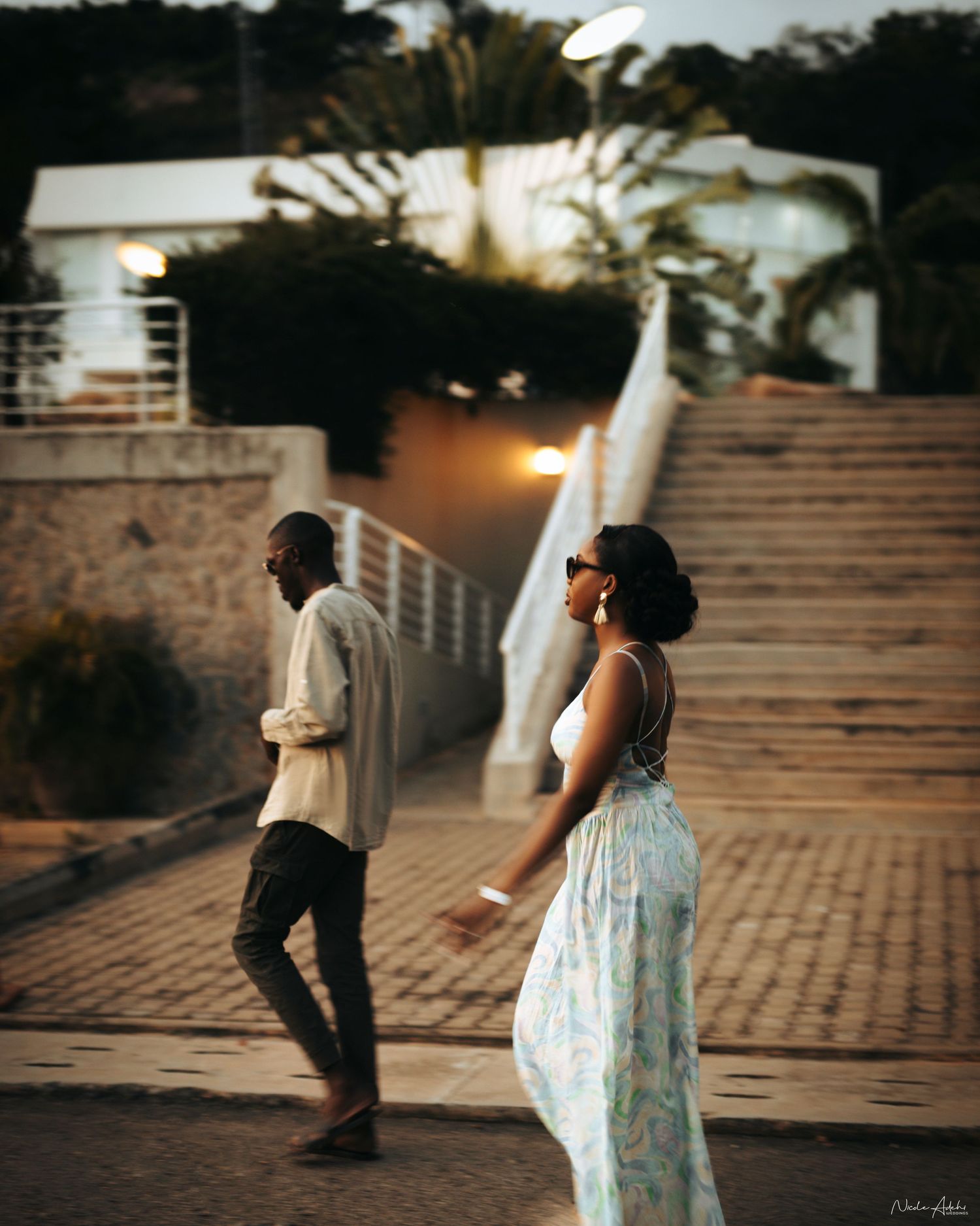 Destination wedding in Santorini with multicultural couple walking down white steps