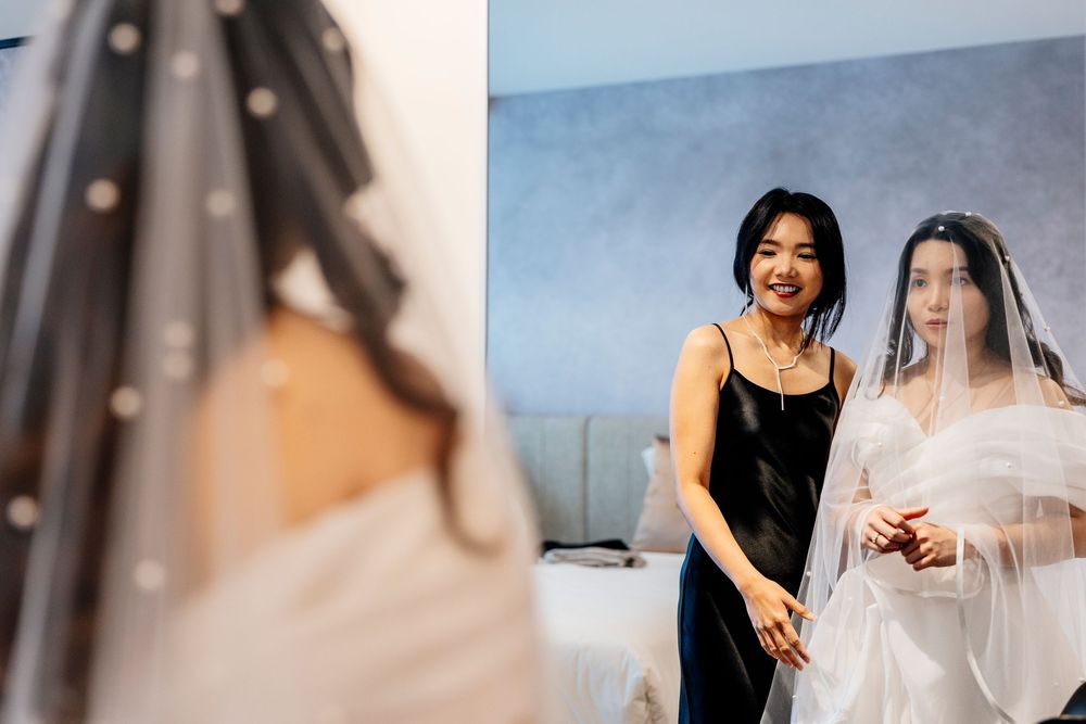 A collection of wedding preparation moments showing dress fittings, veil adjustments and bridal styling in soft natural light.