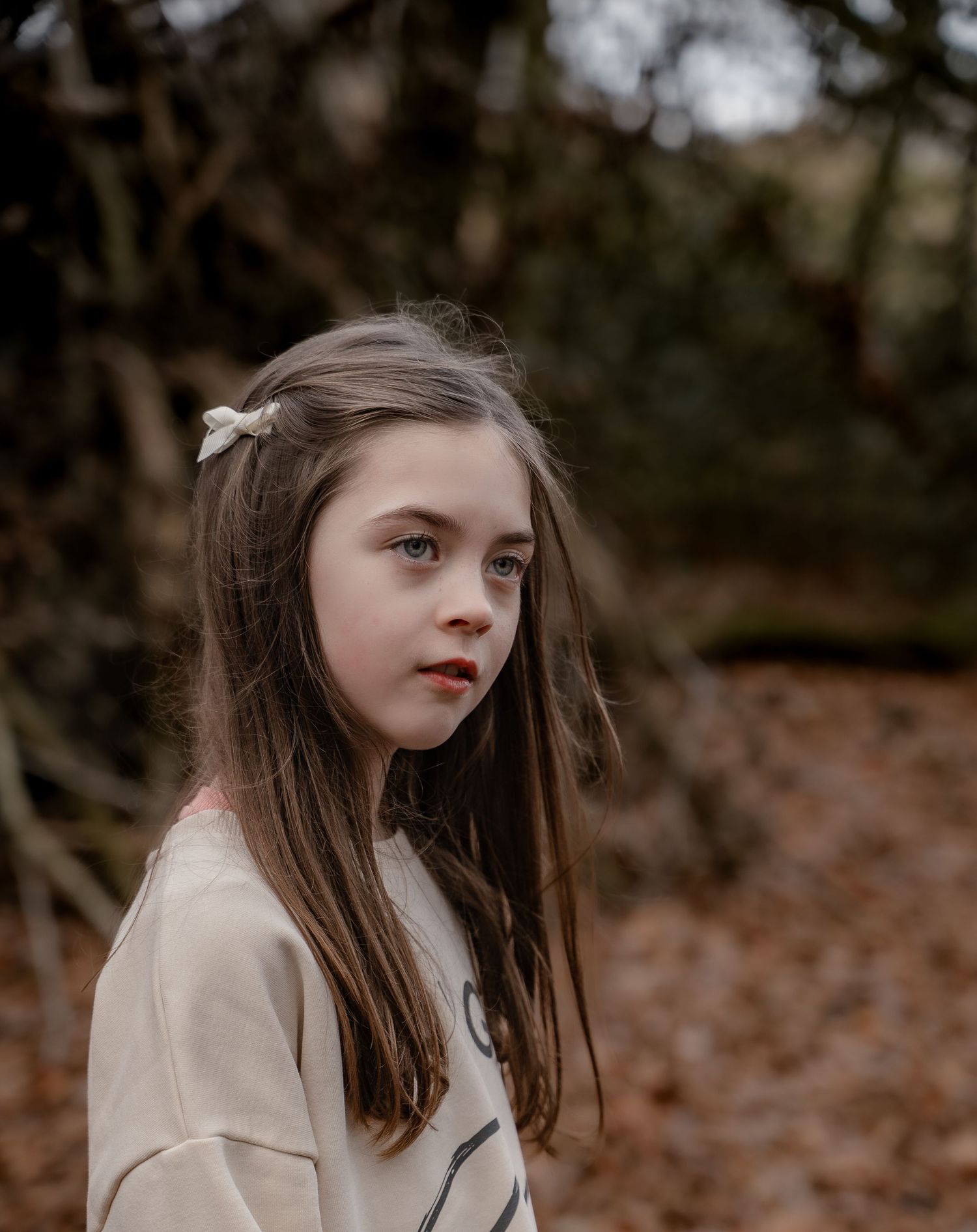 Lifestyle photoshoot in Derbyshire capturing authentic family moments among fallen leaves.