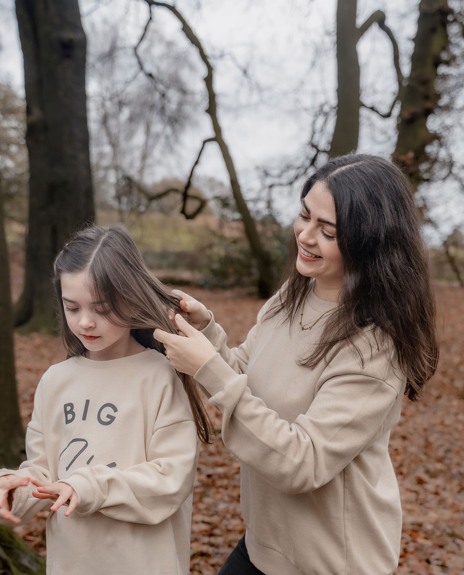 Candid storytelling family photography capturing muddy boots and warm cuddles on an autumn afternoon.
