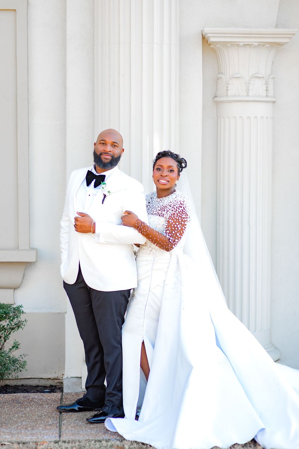 A wedding couple shares playful and romantic poses against white columns in a series of four connected photos.