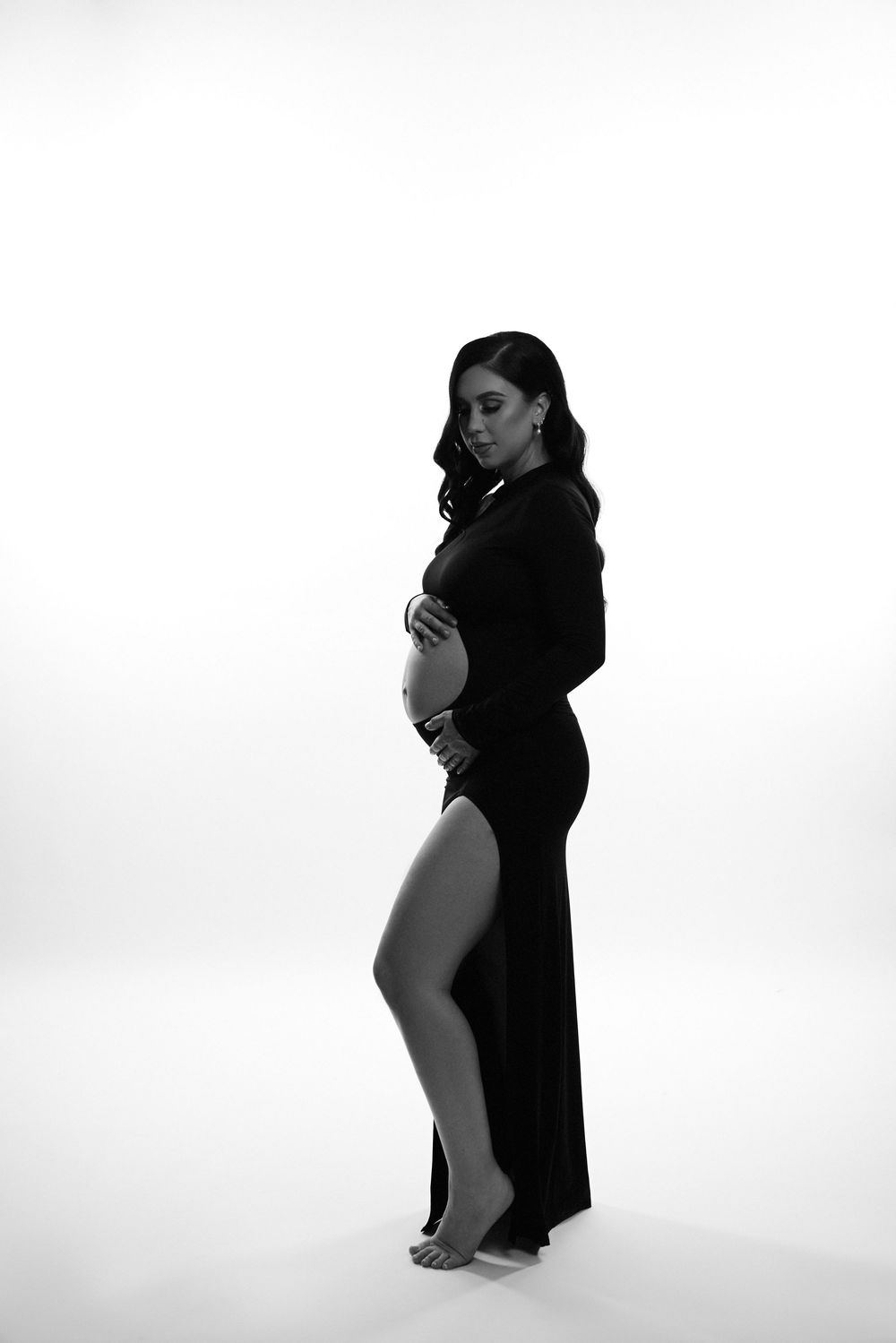 Minimalist black and white maternity portraits on white background.