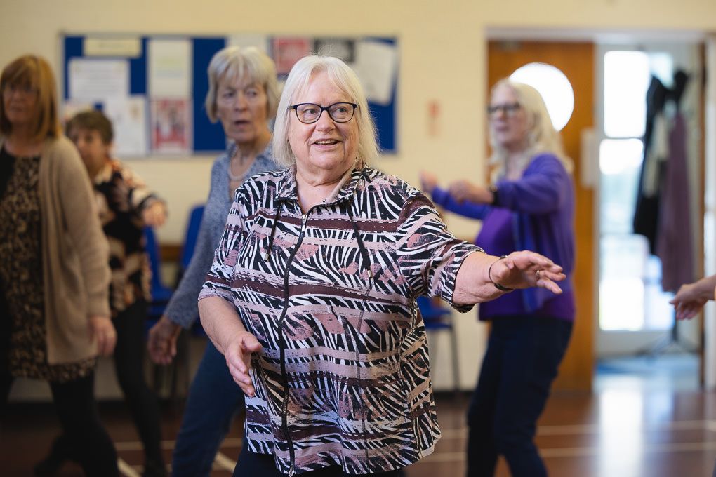 A group of seniors having fun at a dance class in Letchworth, Hertfordshire,