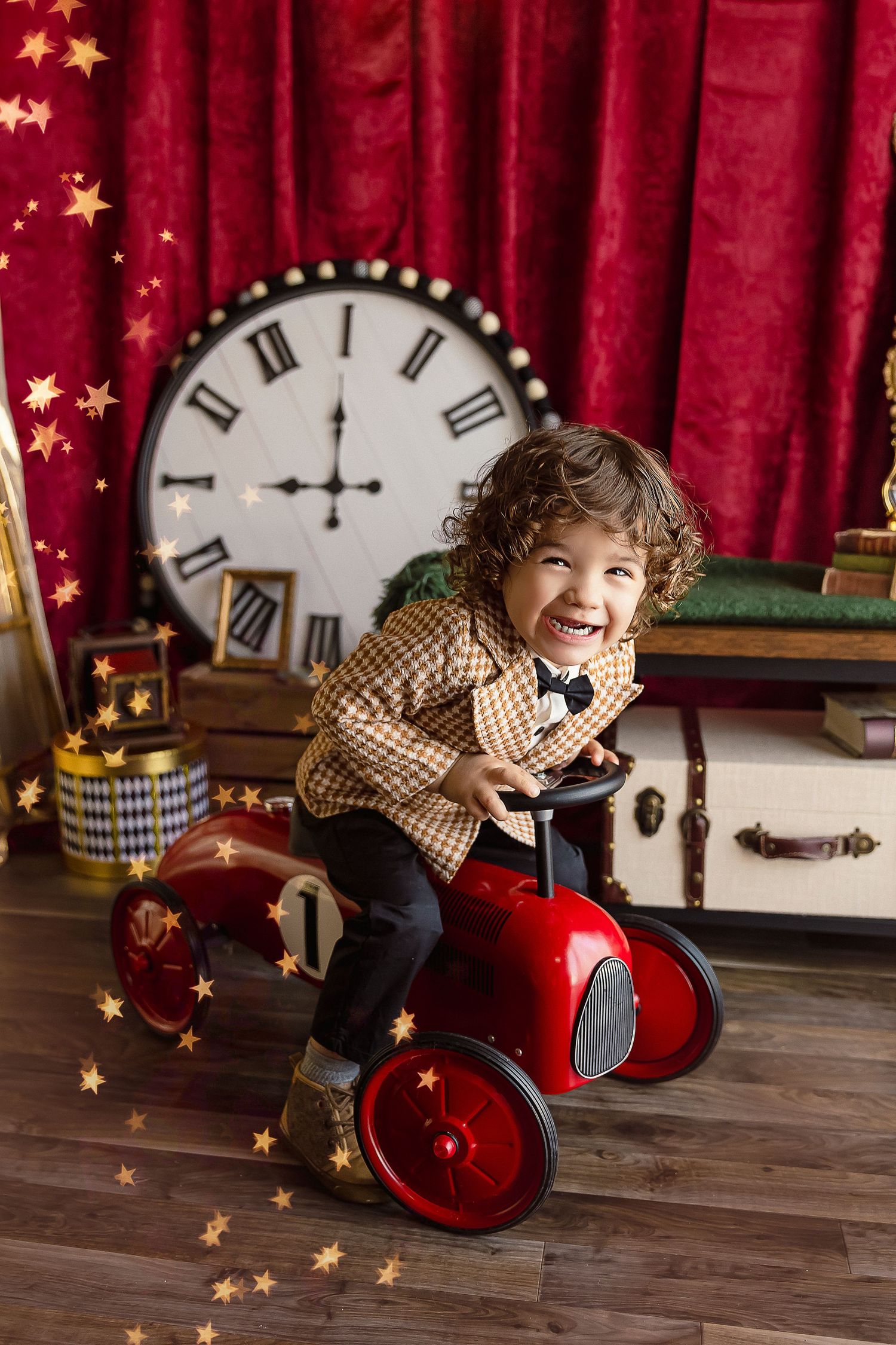 Baby boy riding a red car in a Detres Photography Photoshoot located in Ponce Puerto Rico