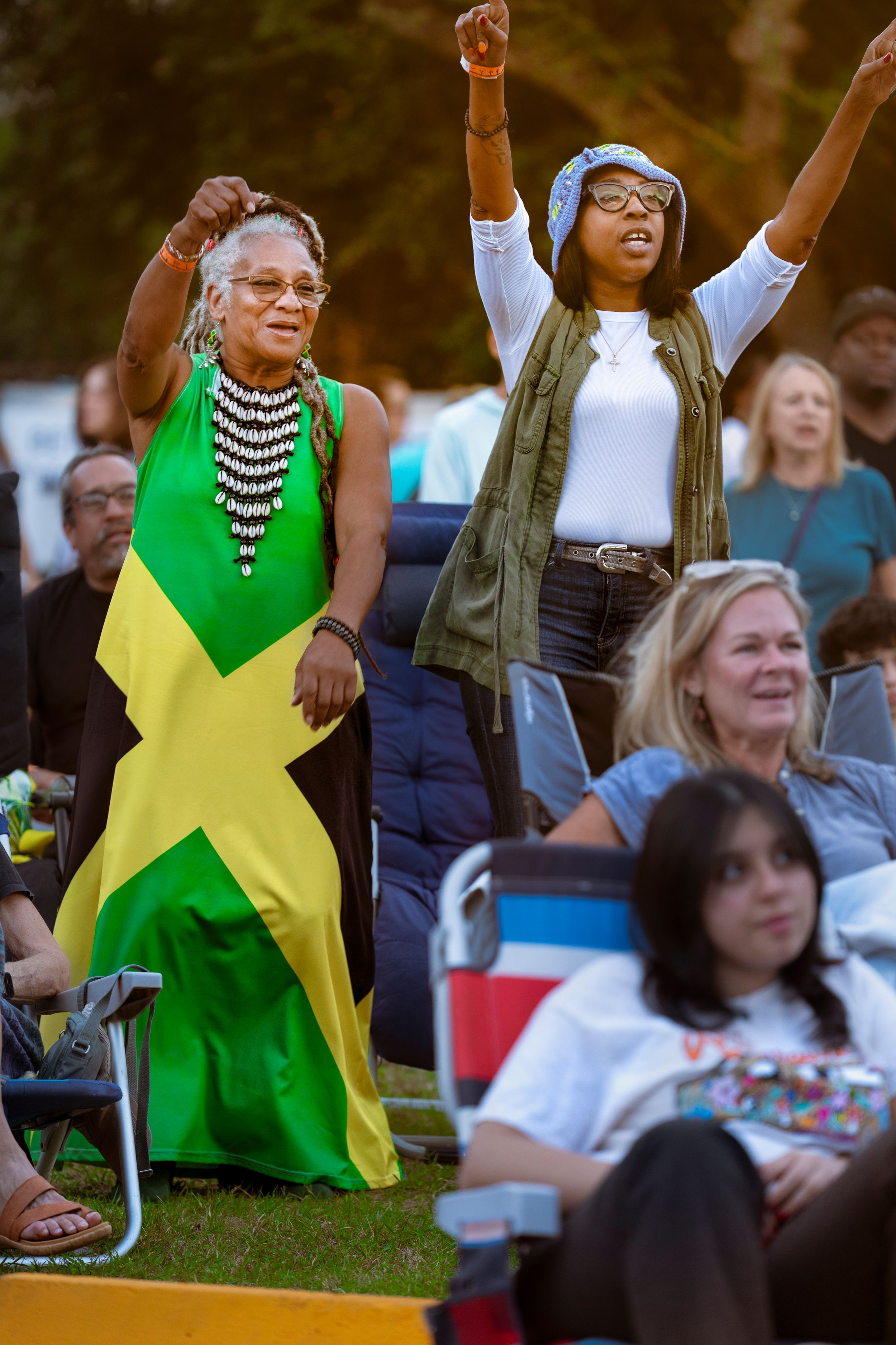 Reggae Festival attendees in bright green and yellow clothing celebrate outdoors. Photography by Tim Ellis at Waterline Brewing company