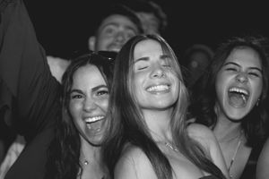 Group of friends laughing and smiling together during a fun social gathering.
