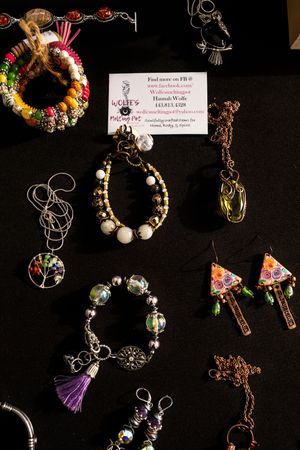 Handmade jewelry collection featuring beaded bracelets, earrings and necklaces displayed on black background.