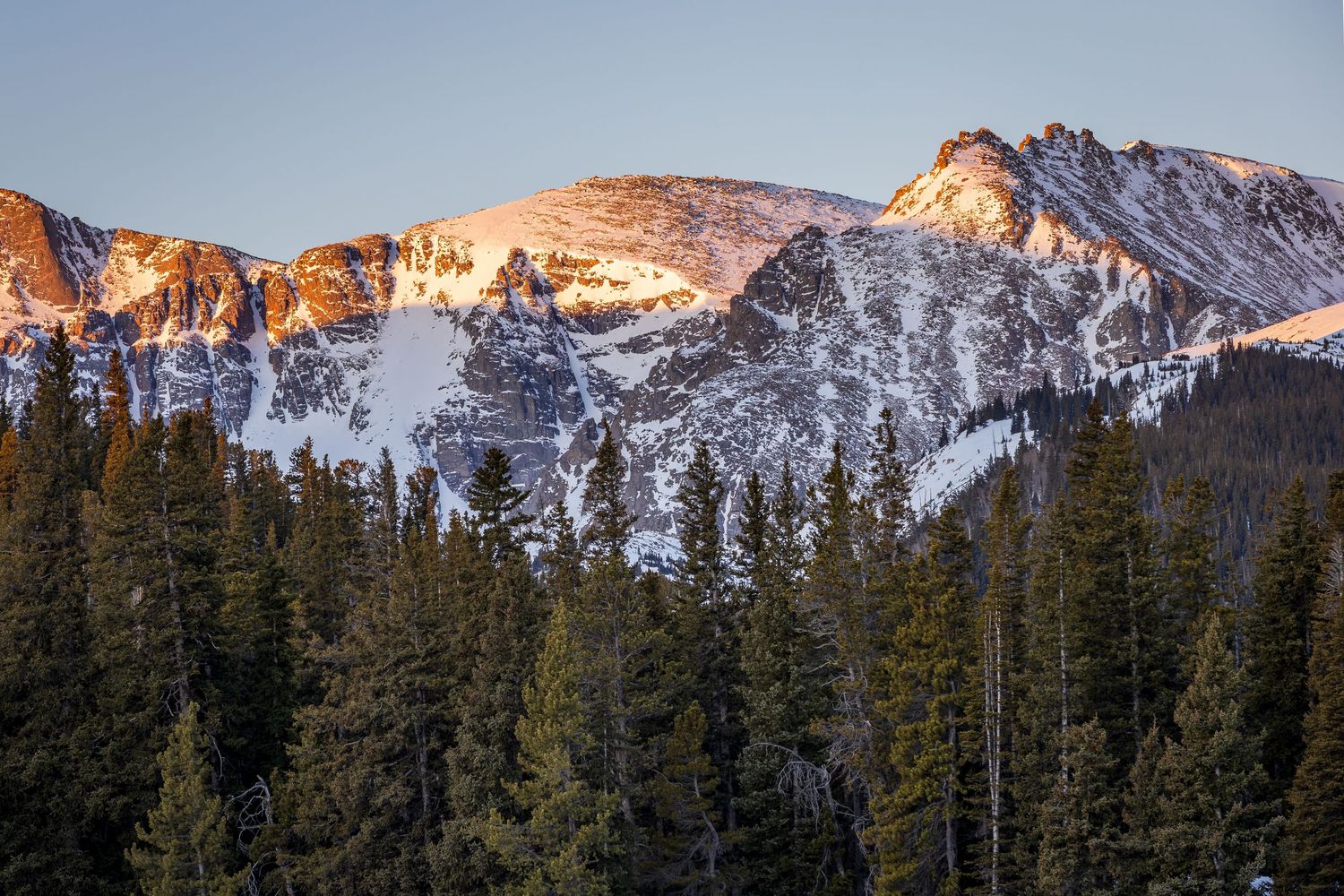 Sunrise kisses the mountain peaks behind this close up shot at Echo Lake, Idaho Springs, Colorado.