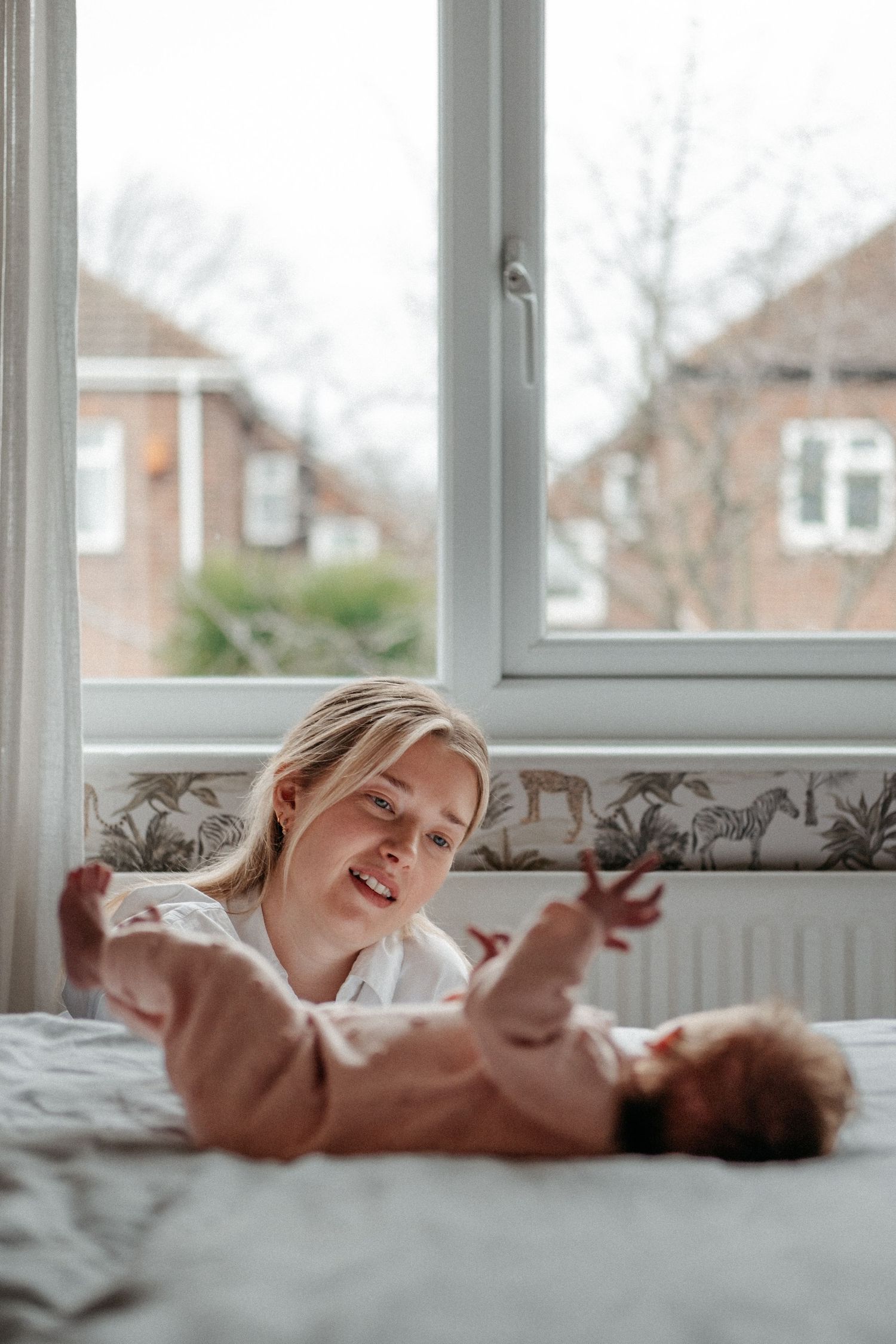 New mother gazing lovingly at her newborn in a family shoot in Gosforth, Benton