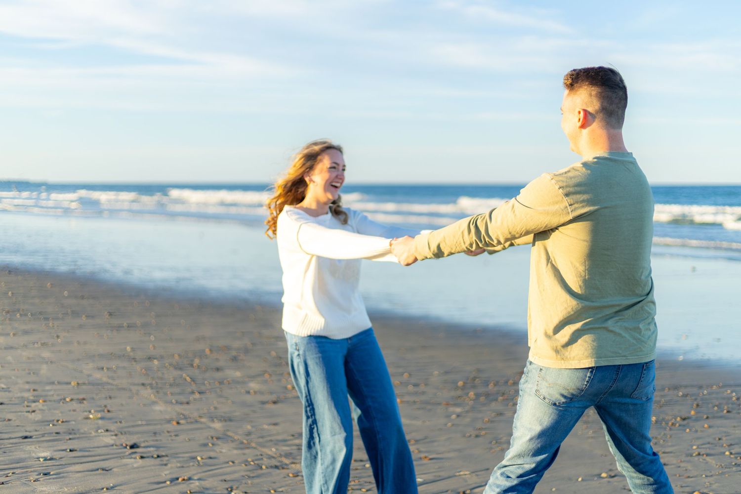 A romantic engagement photo session in a golden marsh field during sunset.