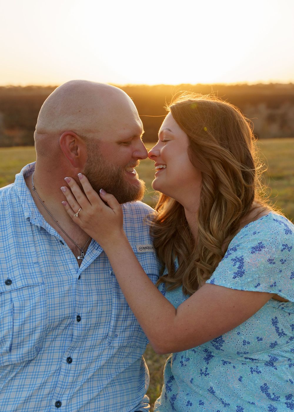 A couple shares a romantic moment at sunset in a series of four connected photos showing them embracing and kissing.