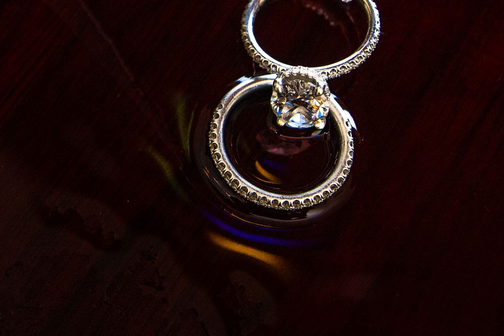 Close-up macro shots of diamond wedding rings with intricate details and reflections.