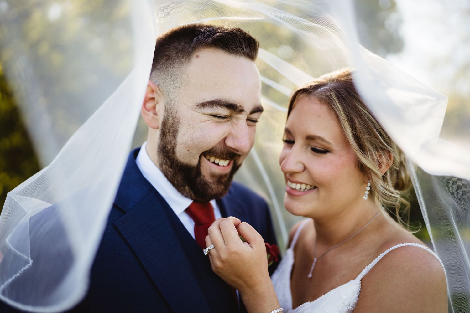 A joyful wedding couple shares intimate moments together in a series of romantic outdoor portrait photographs.
