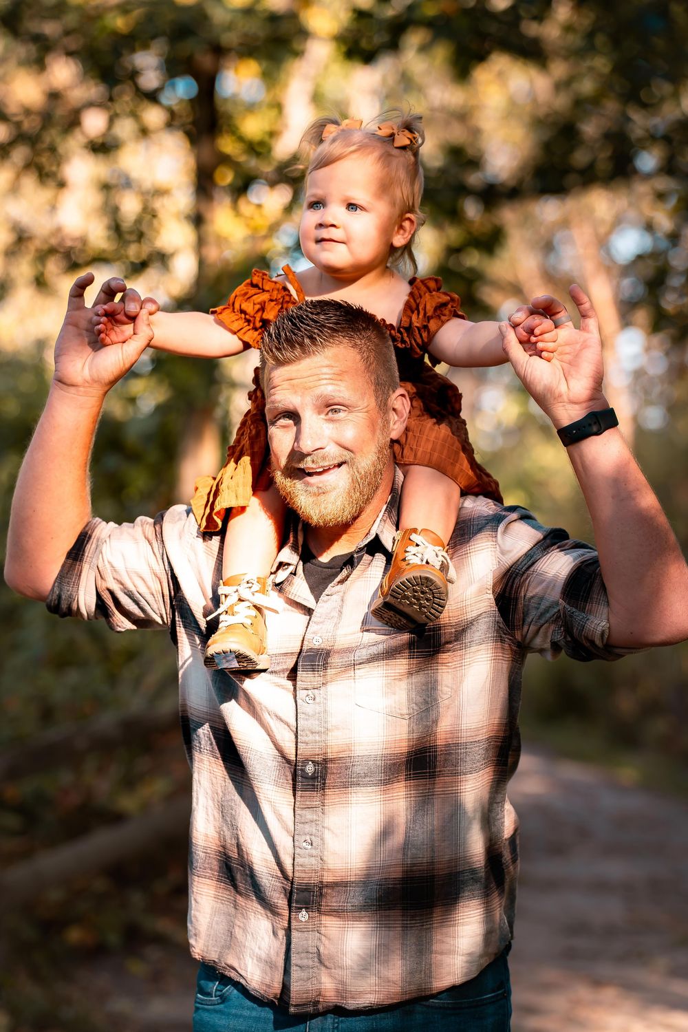 Playful moments captured during outdoor family photo session at sunset.