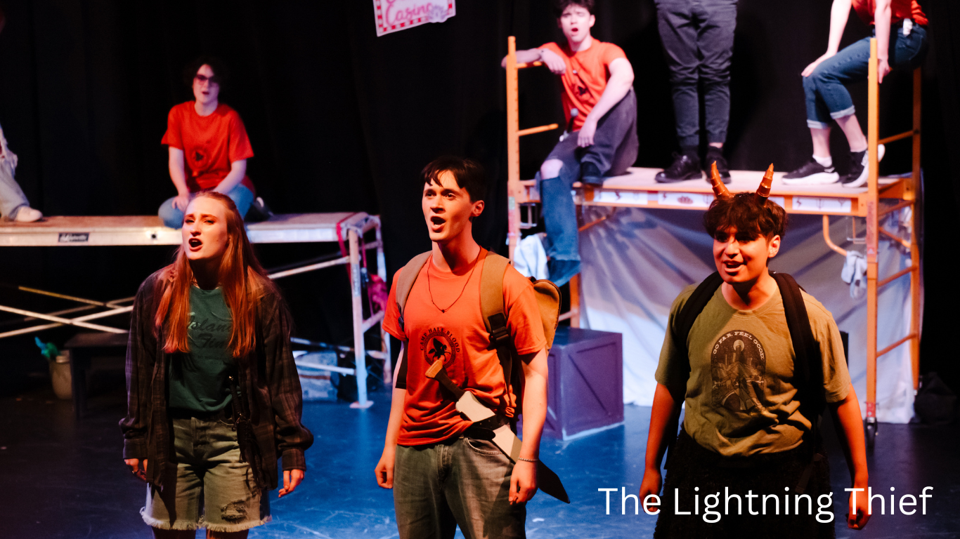 Performers on stage during live theater production of The Lightning Thief.