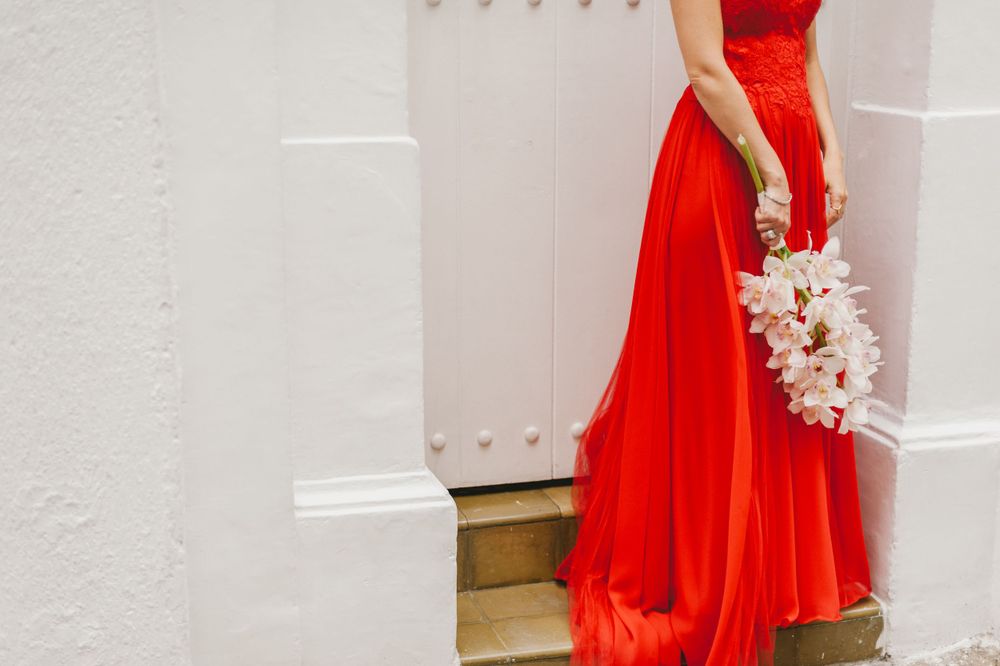 Bride wearing a red dress for her wedding.