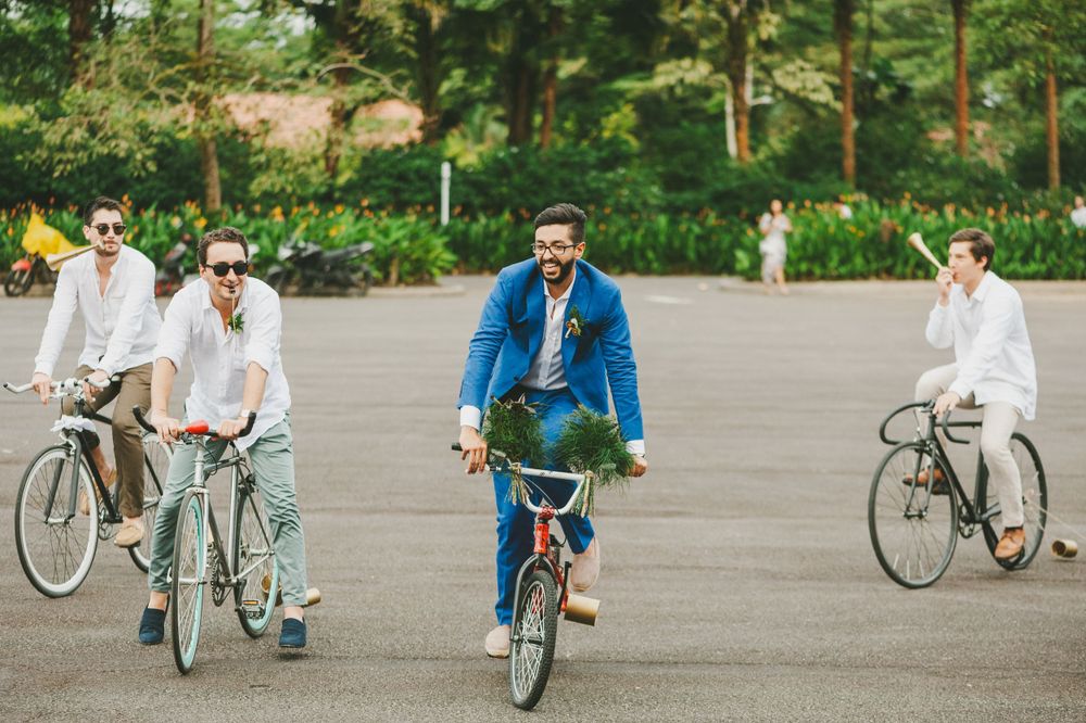 Groom and best men arriving to wedding ceremony riding  bicycles.