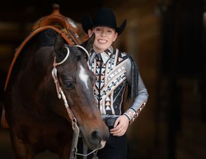 Western style equine portrait with horse and rider in decorated show attire.