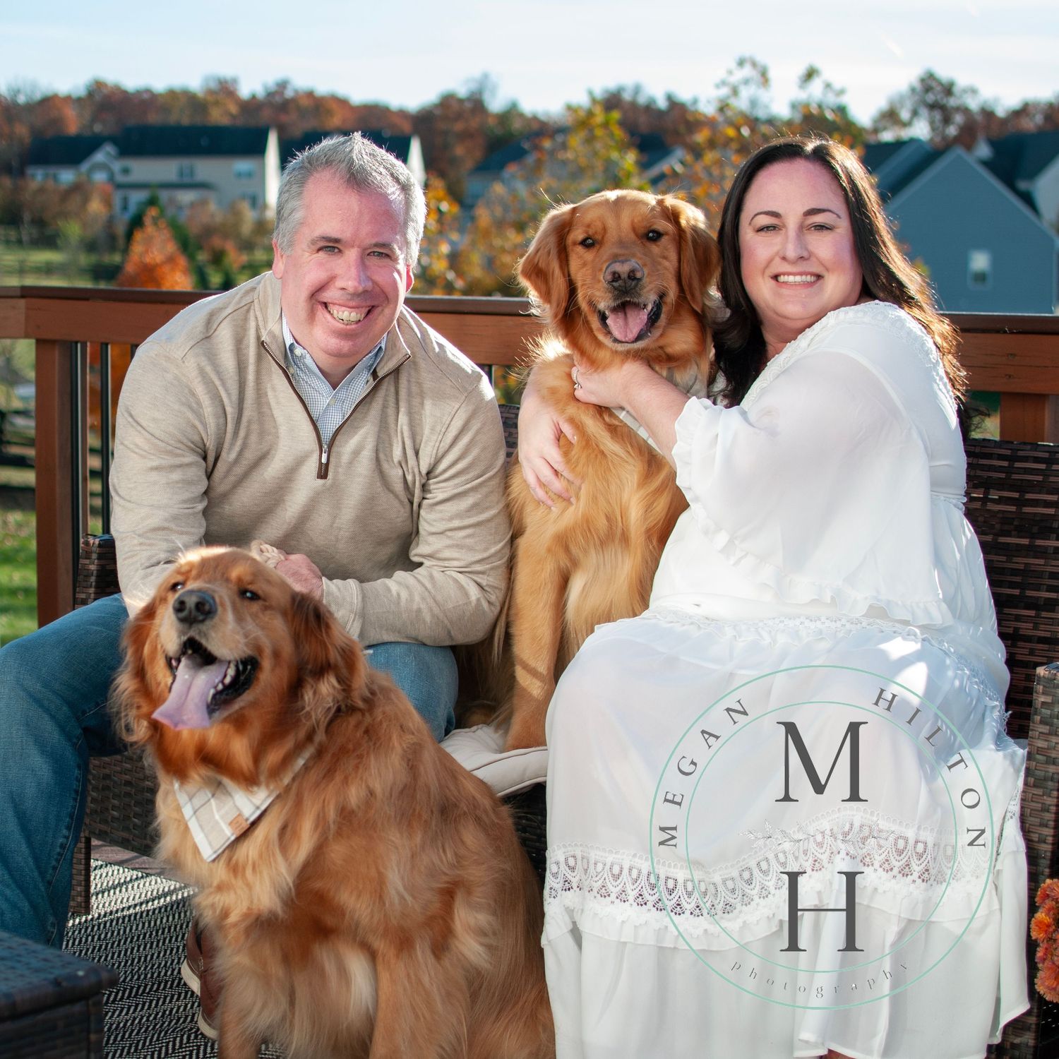 Smiling family photo with pets