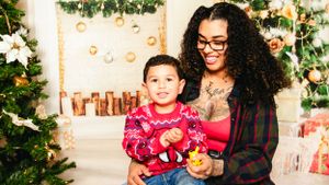 Festive Christmas photoshoot with decorated tree and holiday decorations.