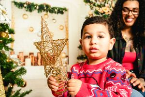 Joyful holiday photoshoot with Christmas decorations and sparkling star ornaments.