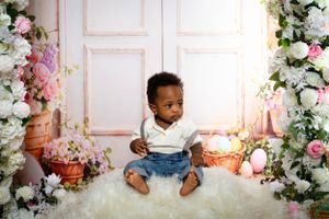 Easter themed photo setup with spring flowers and decorative elements.