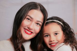 Close-up studio portrait with warm lighting and festive holiday atmosphere.