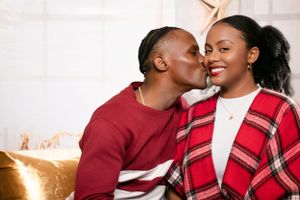 Intimate couple portrait with festive red and white holiday attire.