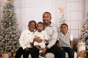 Family group poses together in matching white and grey casual wear.