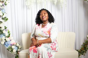Family portrait session with floral decorations and white backdrop.