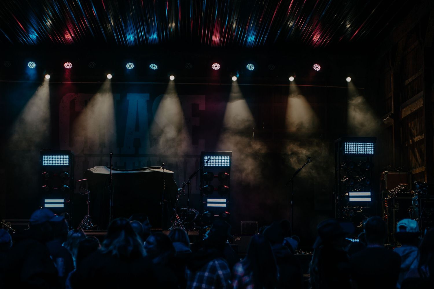 Concert stage lighting setup with colorful spotlights and smoke effects.