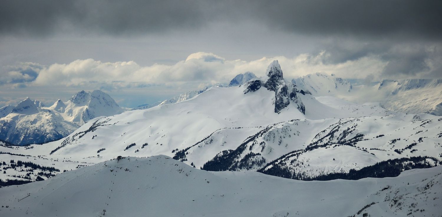 Snow-capped mountain peaks under dramatic cloudy sky in winter landscape.
Whistler Blackcomb
Black Tusk