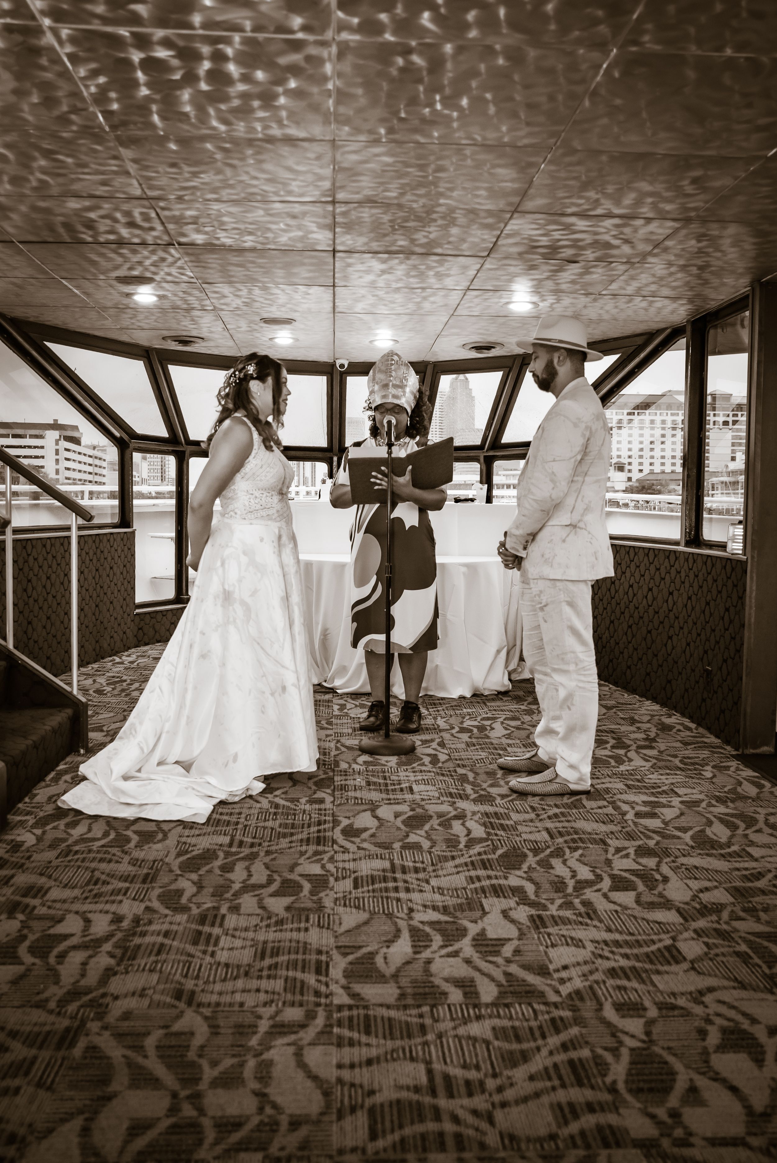 Artistic black and white sequence shows wedding party dancing and celebrating in dramatic shadows.