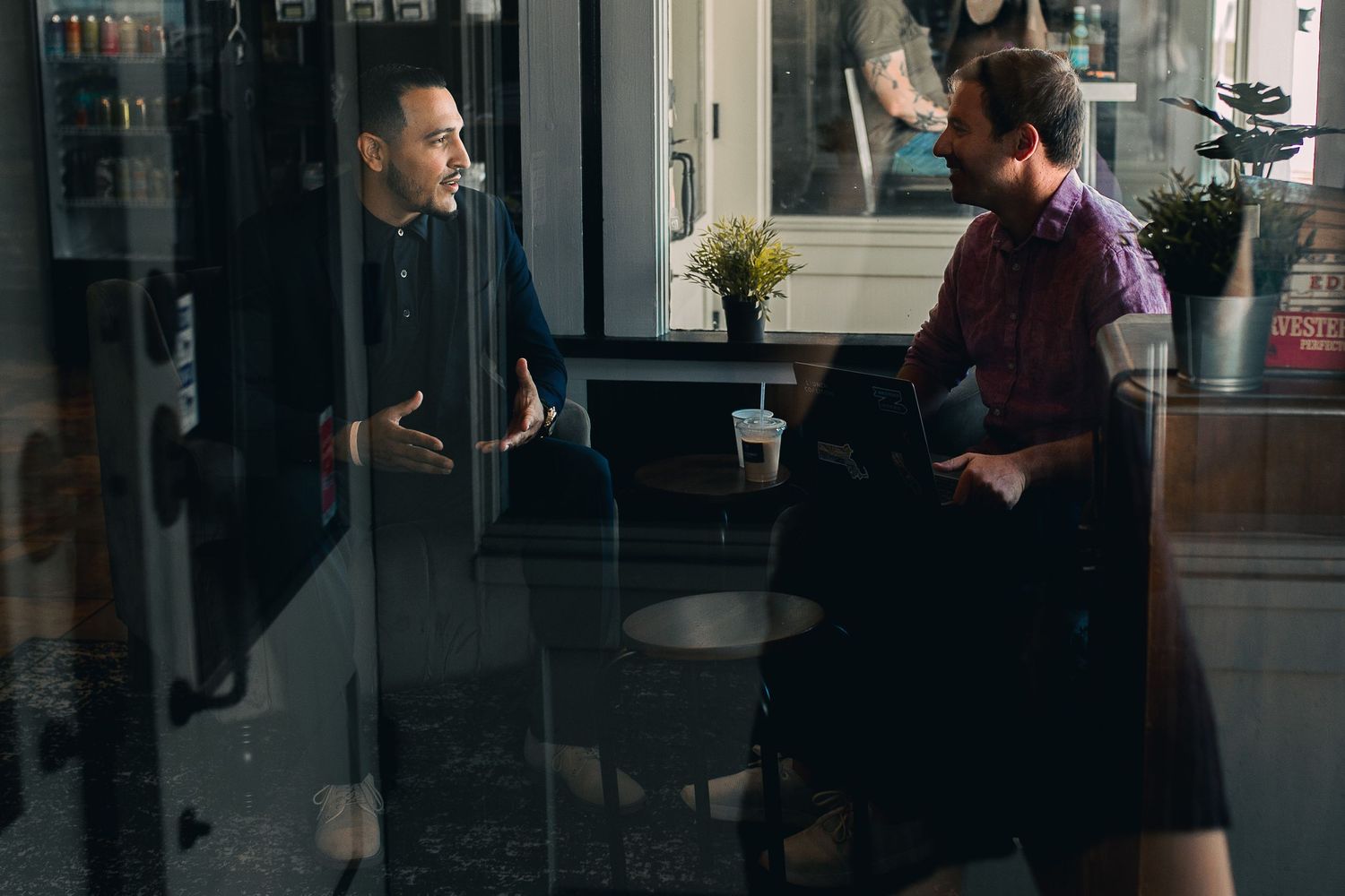 Men sitting across each other talking