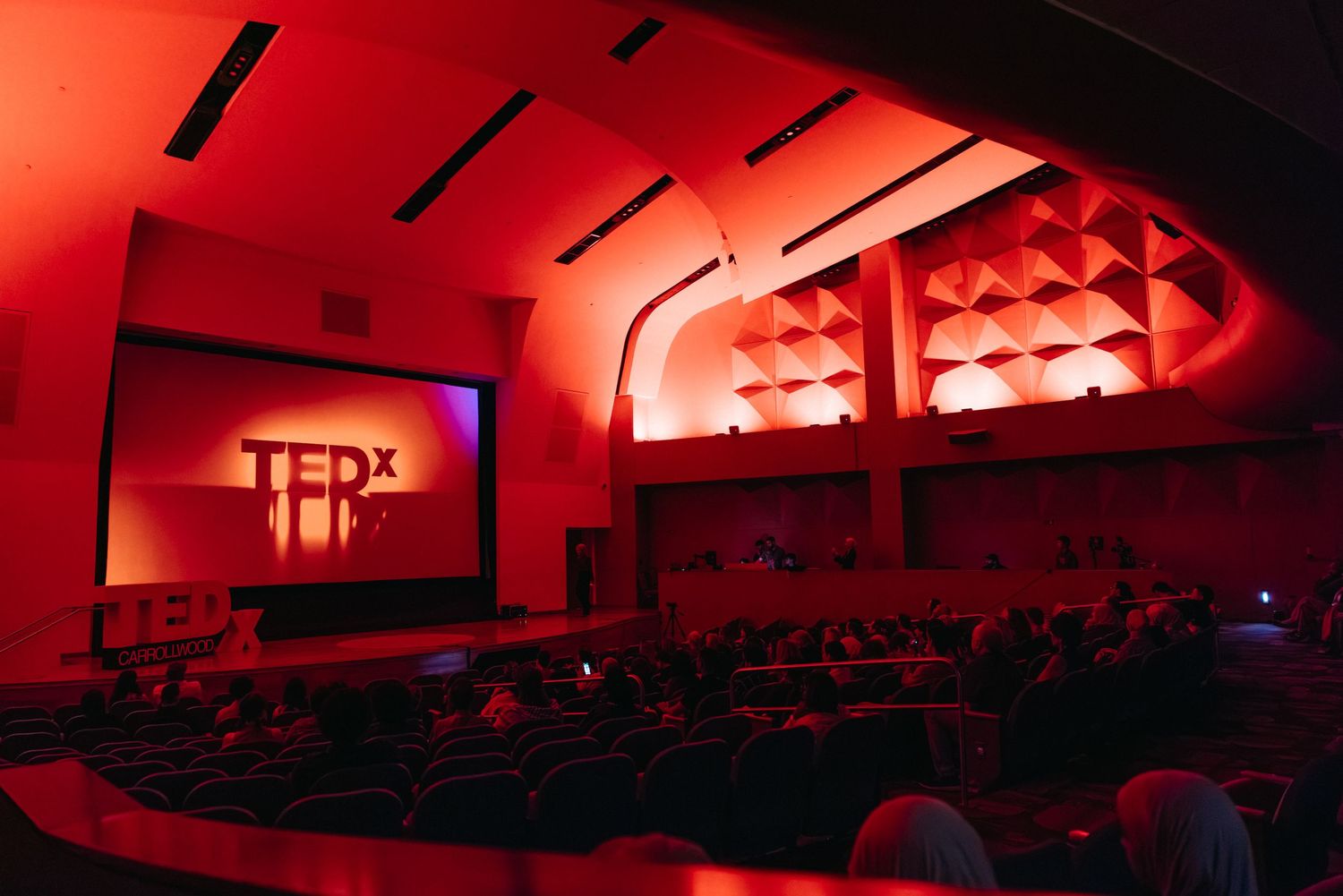 Panoramic view of a formal event space with ornate ceiling and theatrical lighting setup.