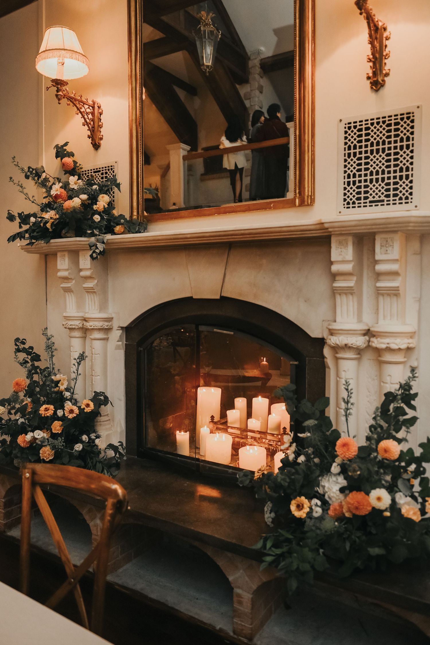 Romantic wedding reception venue with floral arrangements, candles and vintage decor in warm lighting and rustic style.