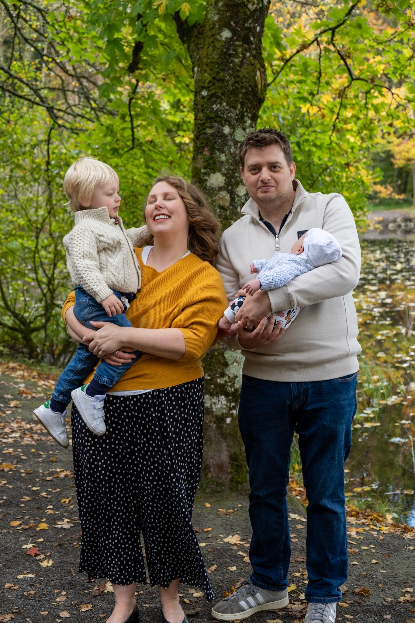 Family shares joyful moment together outdoors during fall season.
