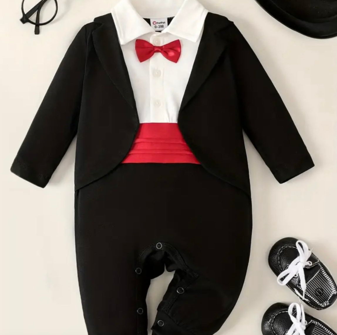 Black and white baby tuxedo onesie with red bow tie and formal details.
