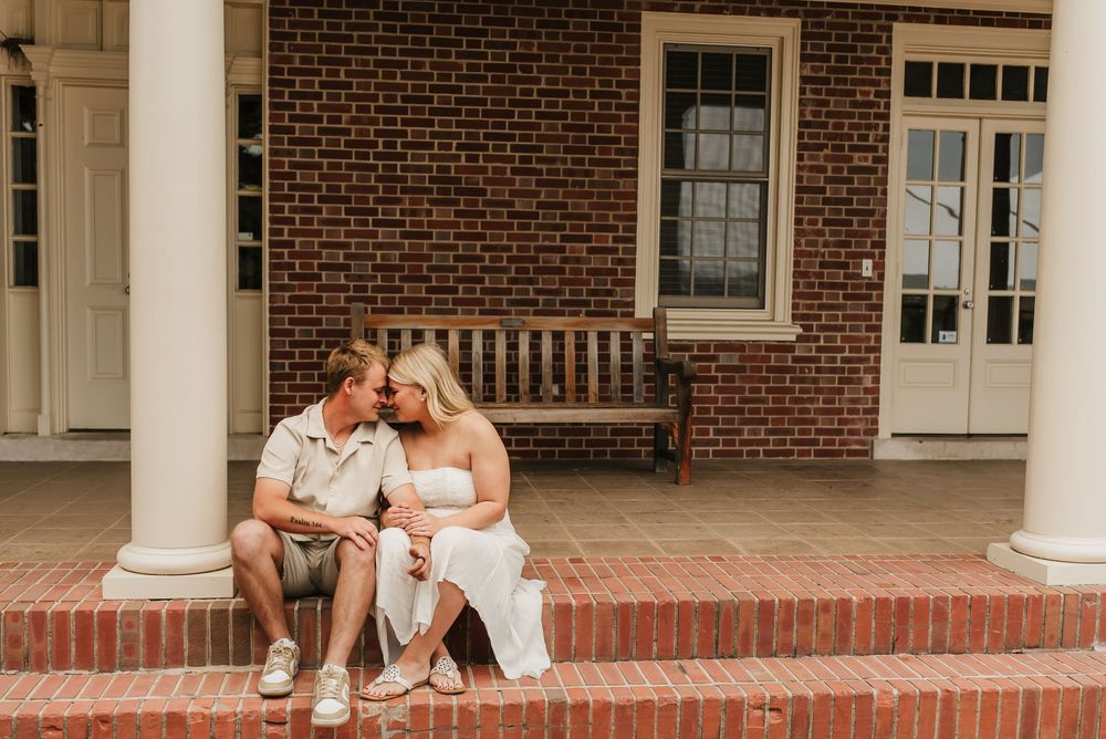 Engaged couple holding hands and smiling during their engagement session.