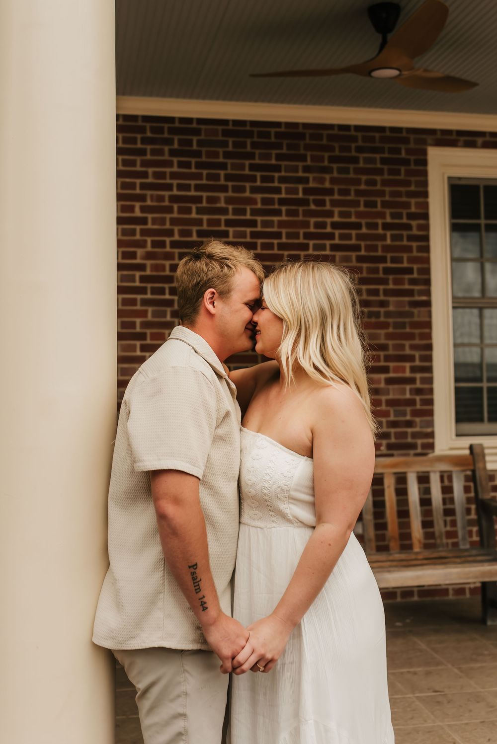 Engaged couple holding hands and smiling during their engagement session.